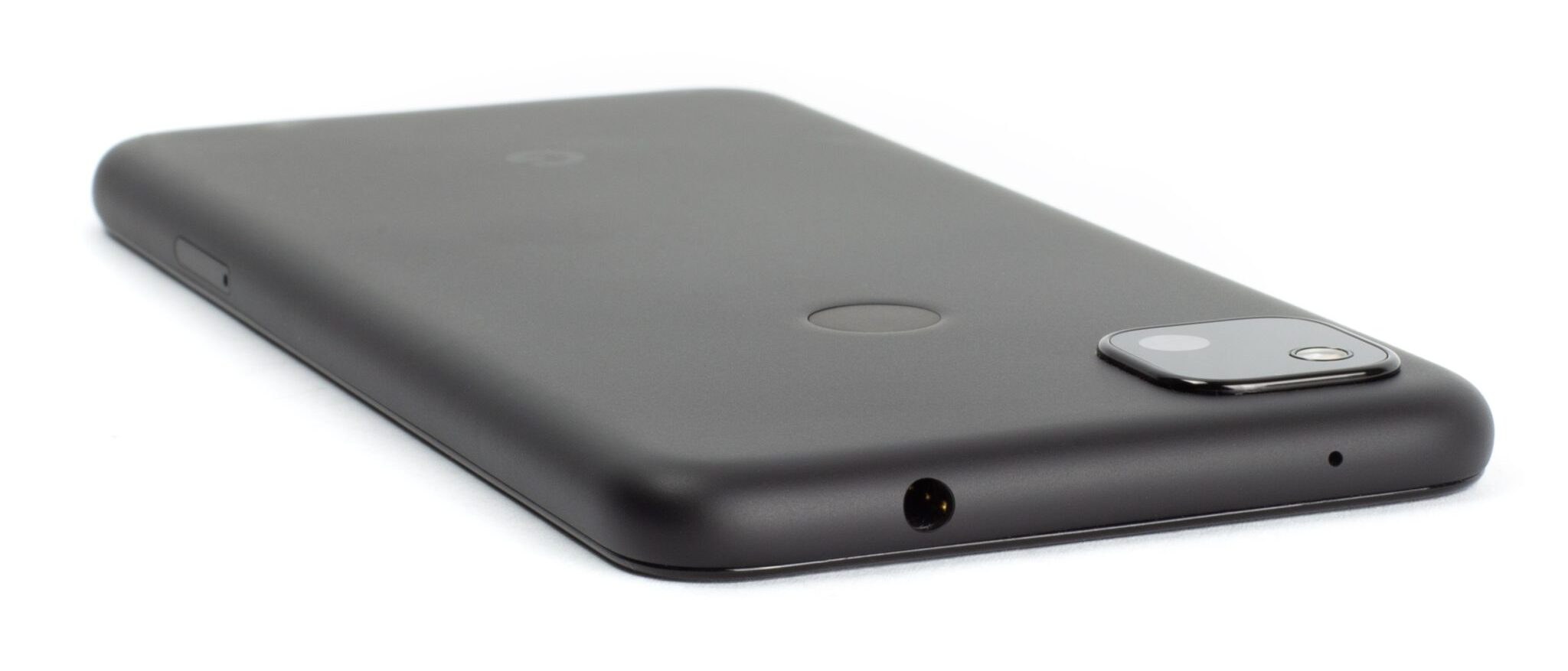 Pixel 4a phone, face down, with headphone jack at the top facing viewer at 45 degrees.
